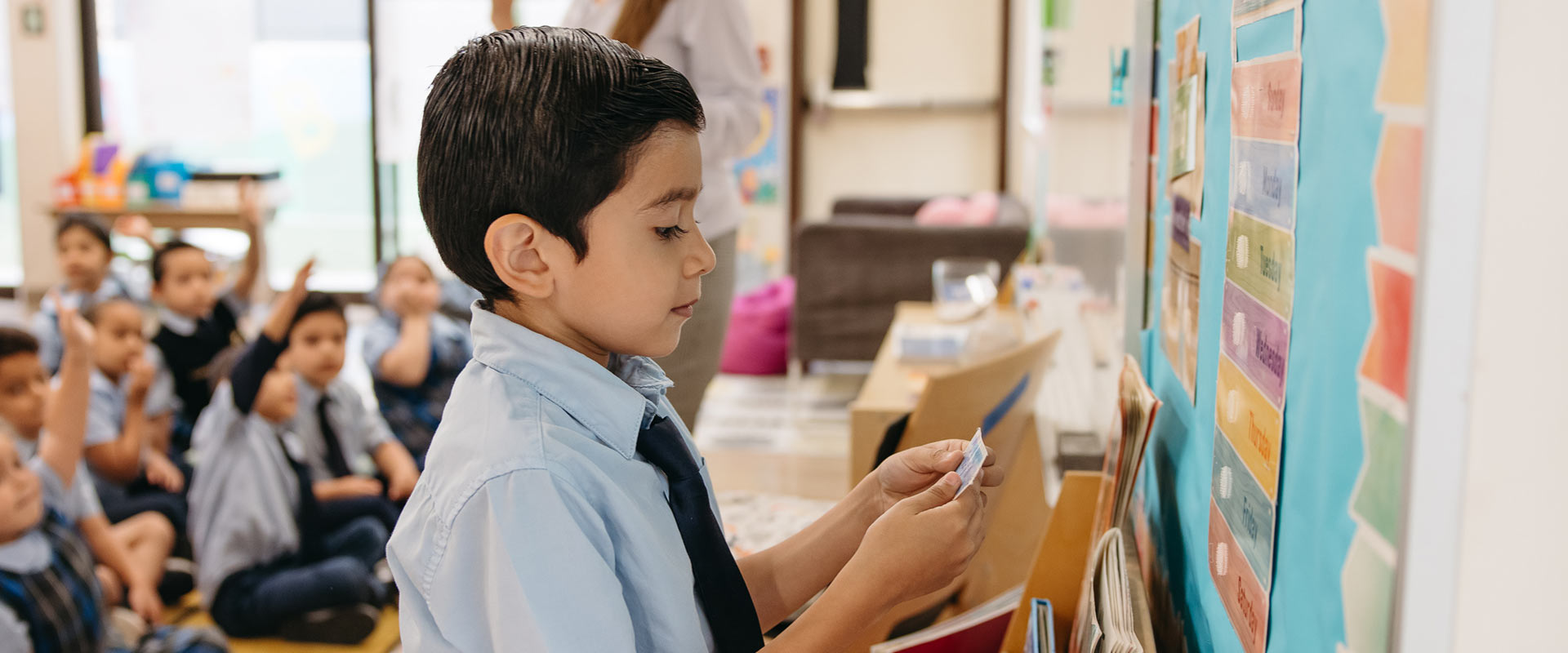 St. Raphael student at front of class reading card