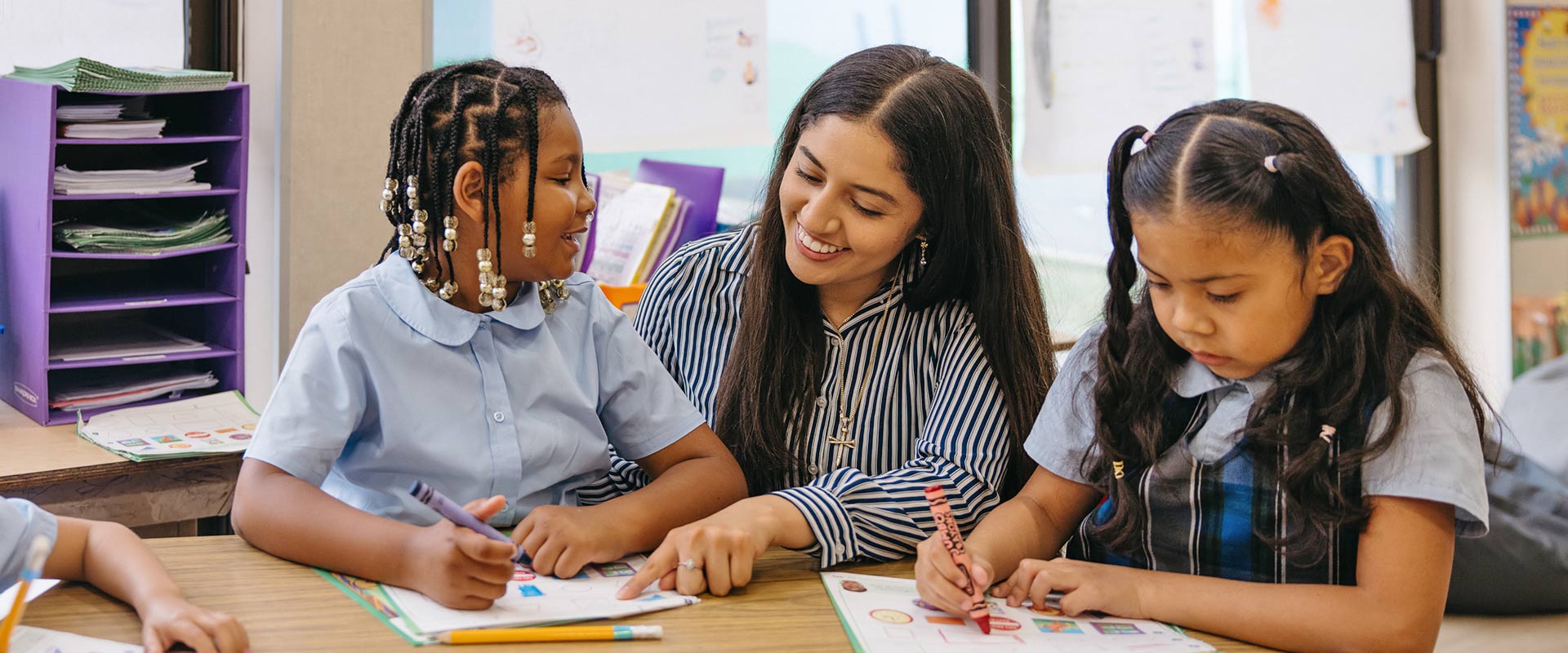 Teacher assisting students